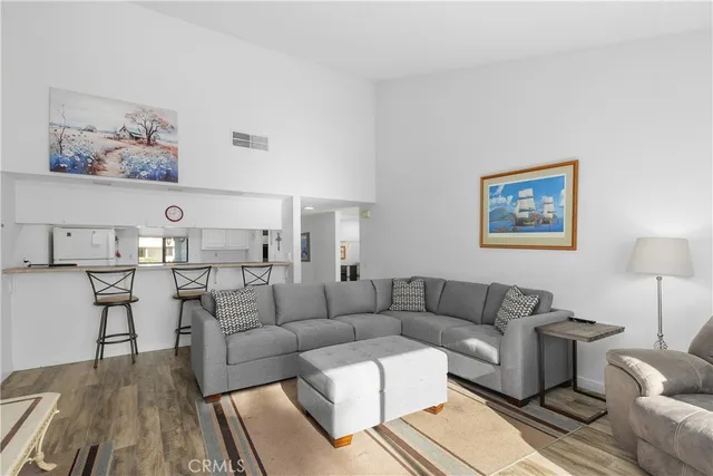 a living room with furniture a rug and a table