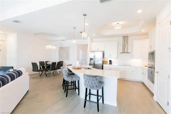 a kitchen with center island table and chairs in it