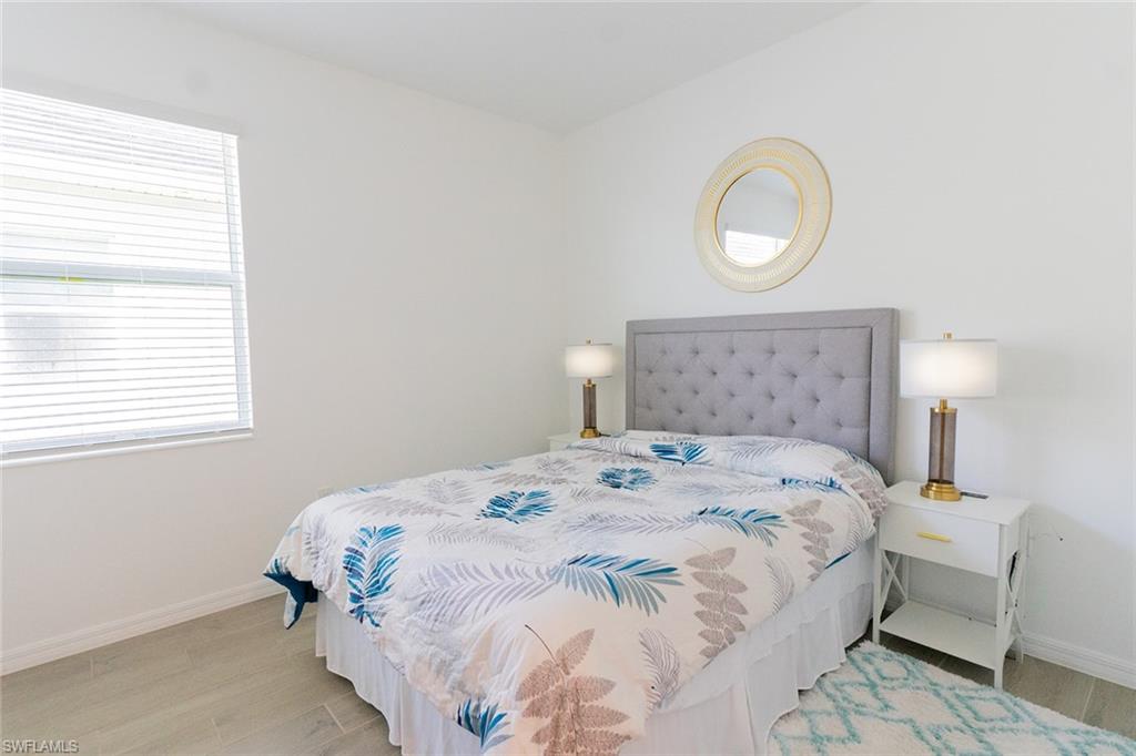 5534 Hampton Links Court Ave Maria, FL 34142 - Photo 16 of 50 a bedroom with a bed and a window
