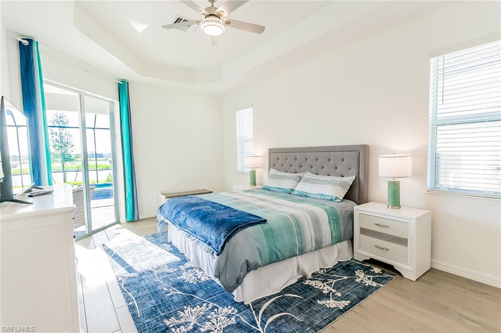 5534 Hampton Links Court Ave Maria, FL 34142 - Photo 18 of 50 a bedroom with a large bed and a window