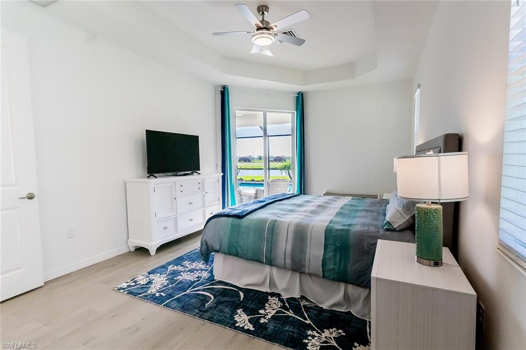 5534 Hampton Links Court Ave Maria, FL 34142 - Photo 19 of 50 a bedroom with a bed and a flat screen tv