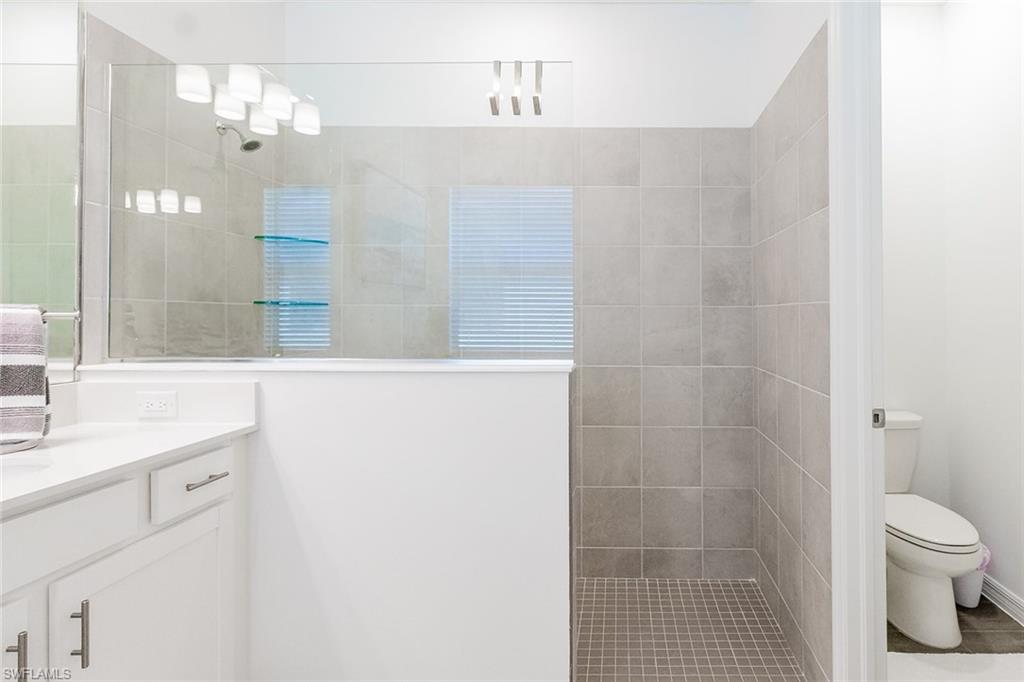 5534 Hampton Links Court Ave Maria, FL 34142 - Photo 21 of 50 a bathroom with a sink a toilet and shower