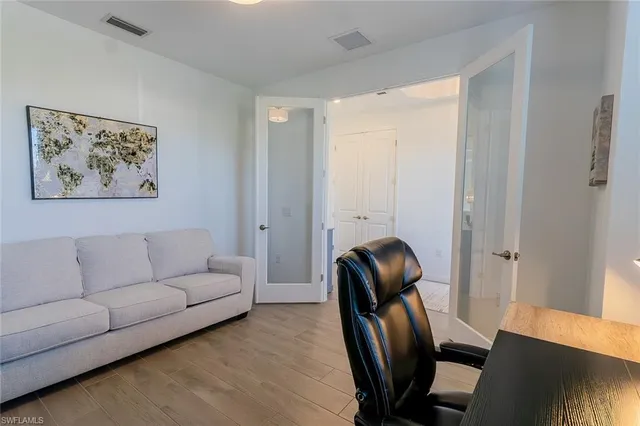 a living room with furniture and a painting