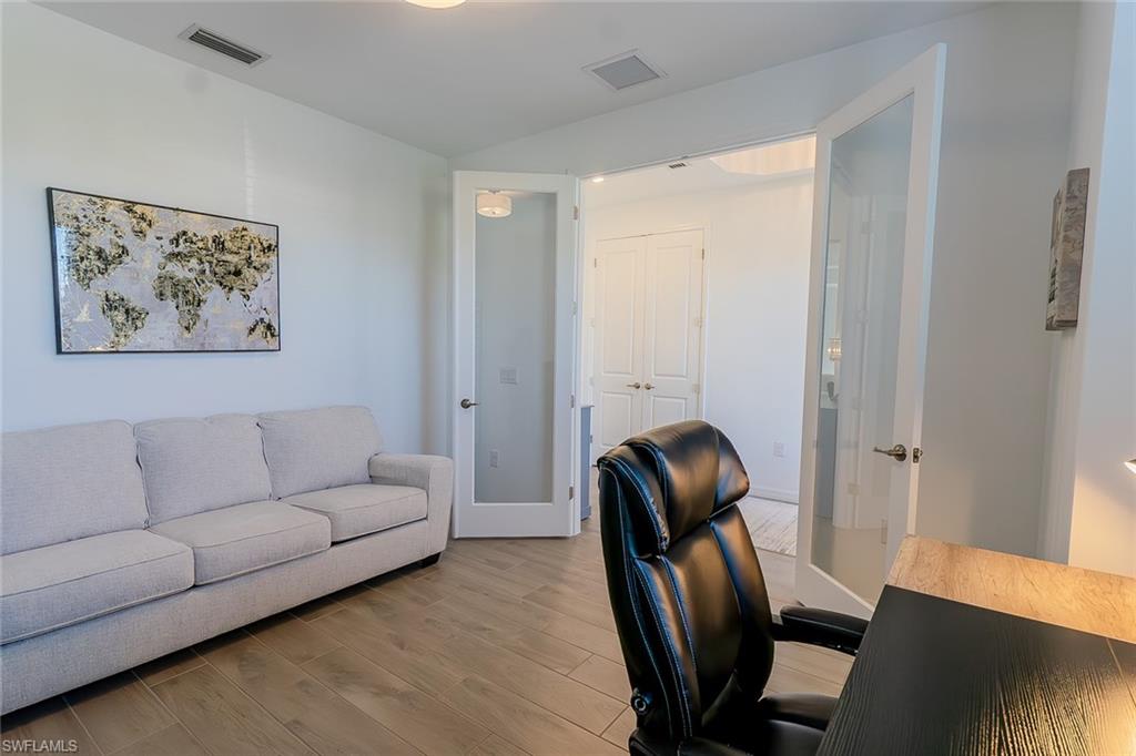 5534 Hampton Links Court Ave Maria, FL 34142 - Photo 25 of 50 a living room with furniture and a painting