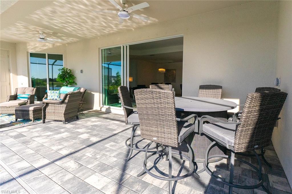 5534 Hampton Links Court Ave Maria, FL 34142 - Photo 29 of 50 a patio with yard glass top table and chairs