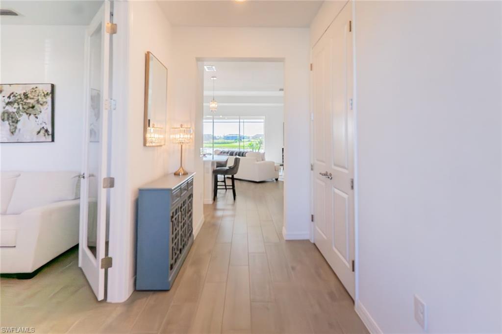 5534 Hampton Links Court Ave Maria, FL 34142 - Photo 31 of 50 a living room with furniture and a wooden floor