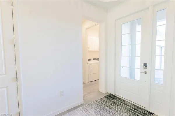 a view of a bathroom with wooden floor and a window
