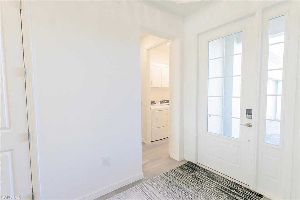 5534 Hampton Links Court Ave Maria, FL 34142 - Photo 33 of 50 a view of a bathroom with wooden floor and a window