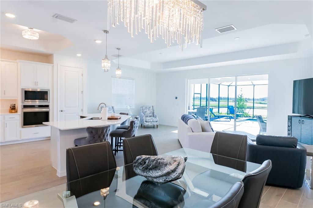 5534 Hampton Links Court Ave Maria, FL 34142 - Photo 5 of 50 a living room with furniture a large window and a table