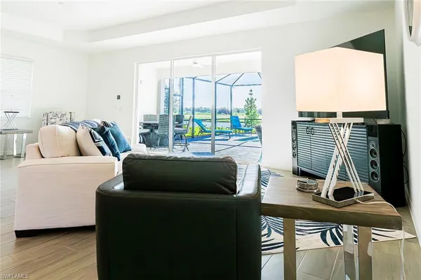 a bedroom with furniture and a large window