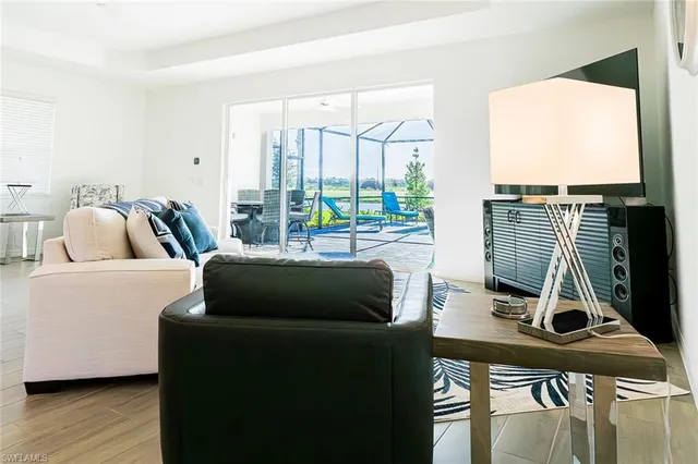 a bedroom with furniture and a large window