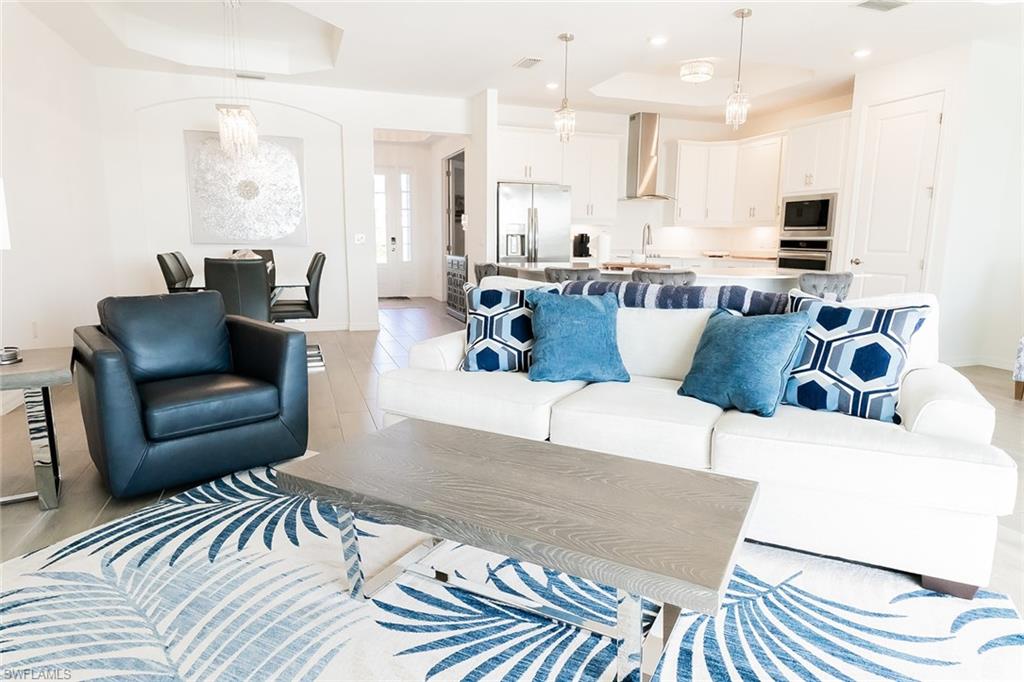 5534 Hampton Links Court Ave Maria, FL 34142 - Photo 8 of 50 a living room with furniture and kitchen view