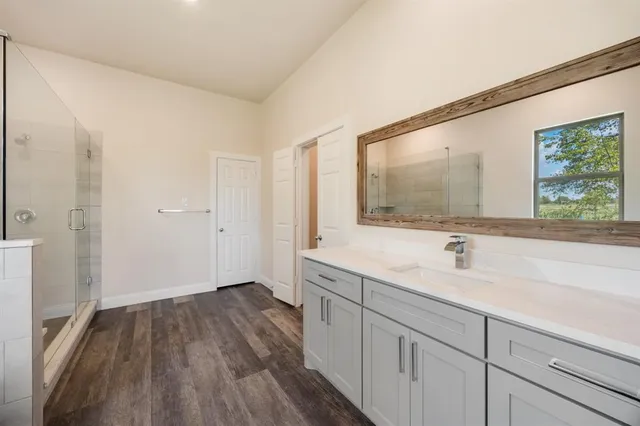 a bathroom with a tub sink and mirror