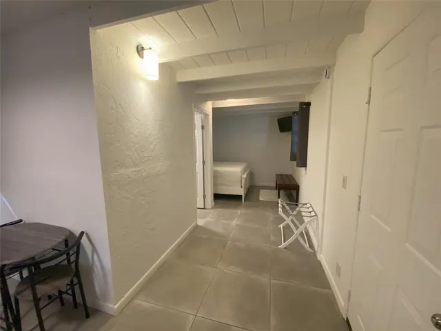 a view of a hallway and a room with a mirror