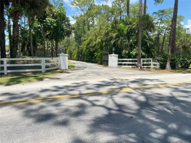 a view of an house with backyard and trees