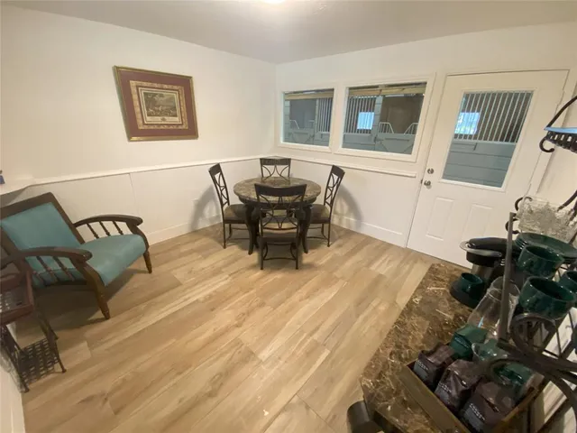 a living room with furniture and floor to ceiling window