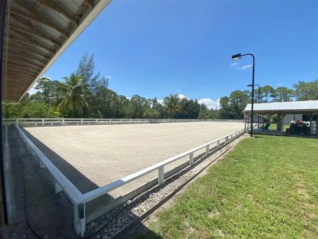 a view of a swimming pool with a patio and a yard