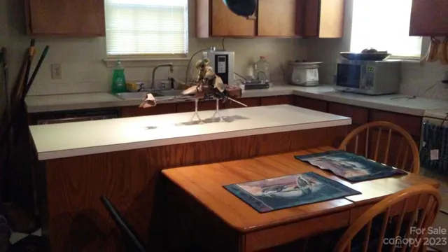 a kitchen with a sink a stove and cabinets