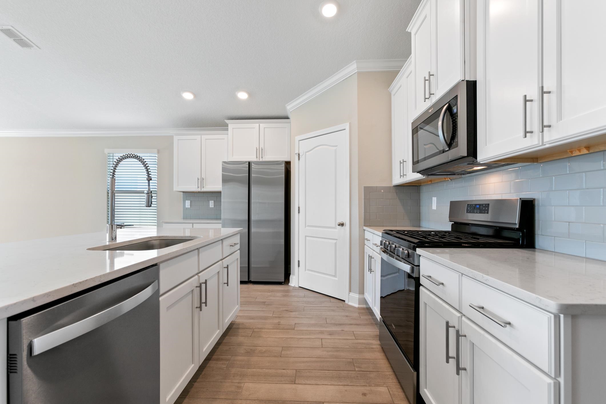 42 Huesca Court St. Augustine, FL 32084 - Photo 12 of 70 a kitchen with stainless steel appliances granite countertop a sink stove and refrigerator