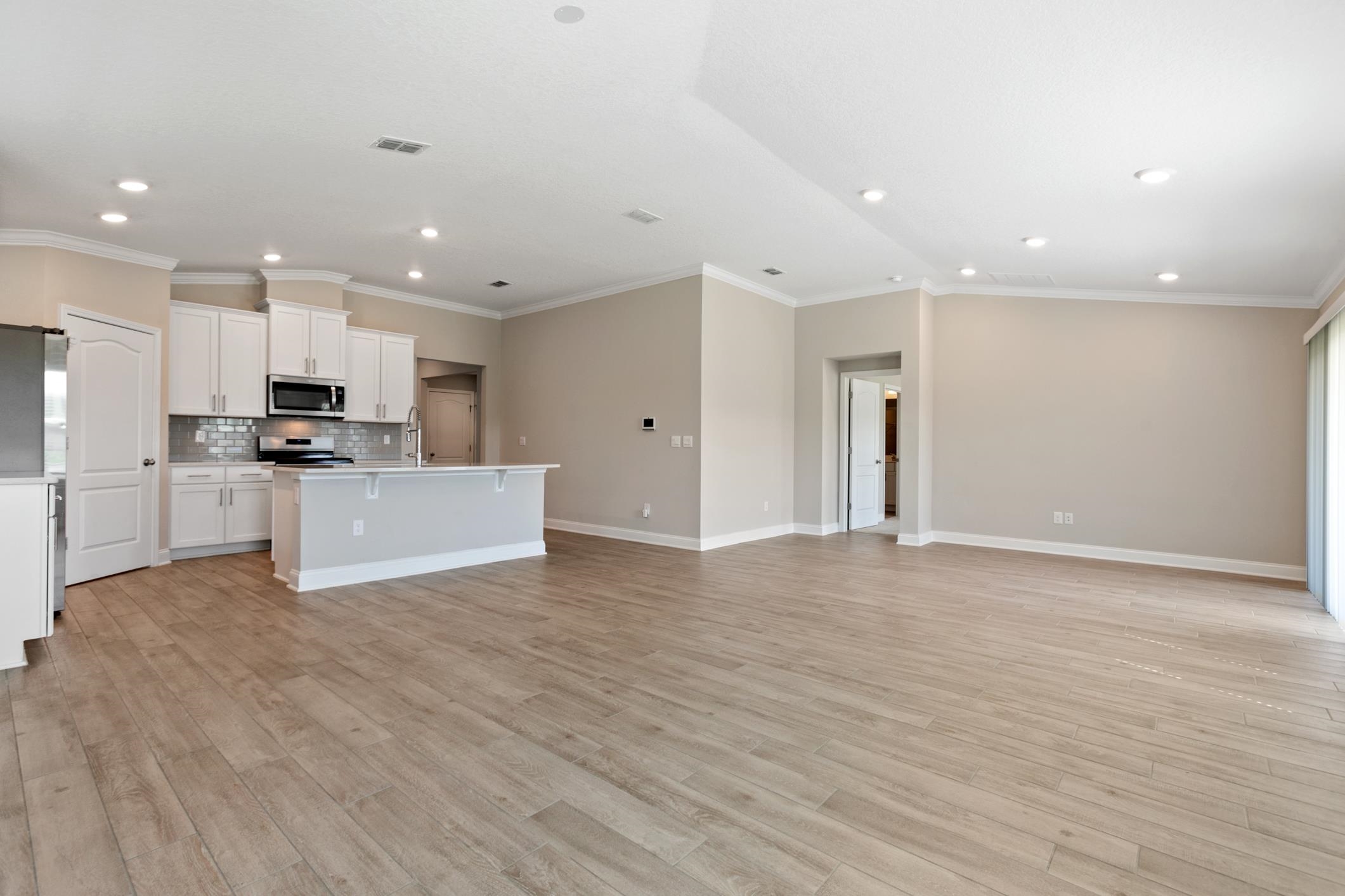 42 Huesca Court St. Augustine, FL 32084 - Photo 19 of 70 a view of kitchen with kitchen island wooden floor center island and stainless steel appliances