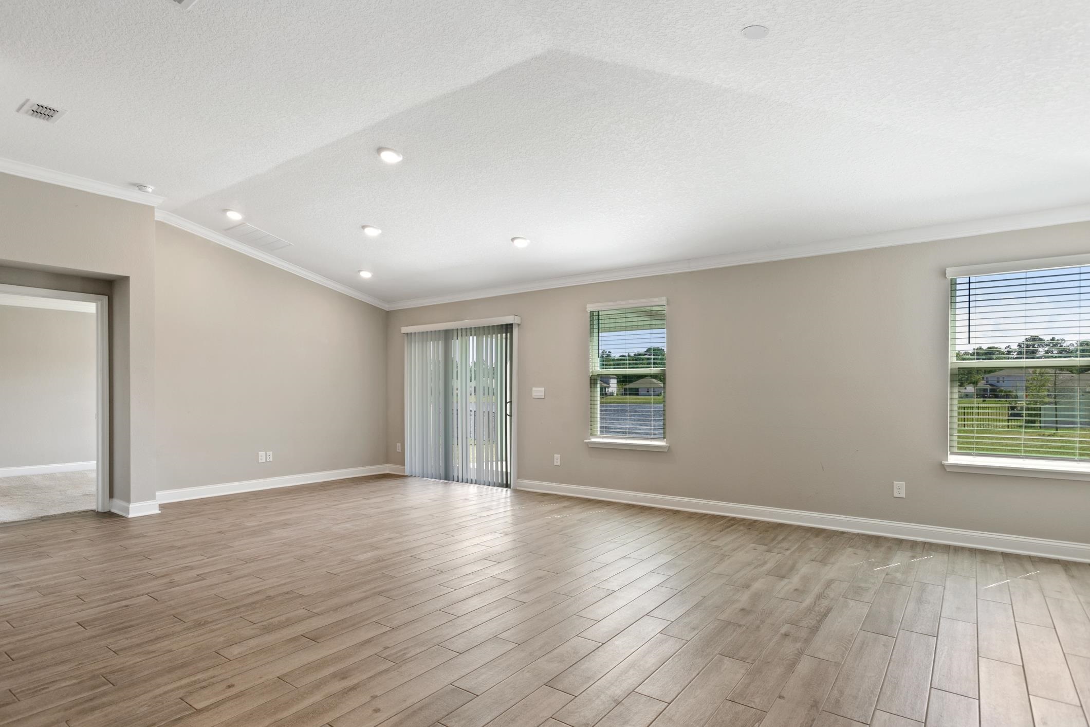 42 Huesca Court St. Augustine, FL 32084 - Photo 22 of 70 an empty room with wooden floor and windows