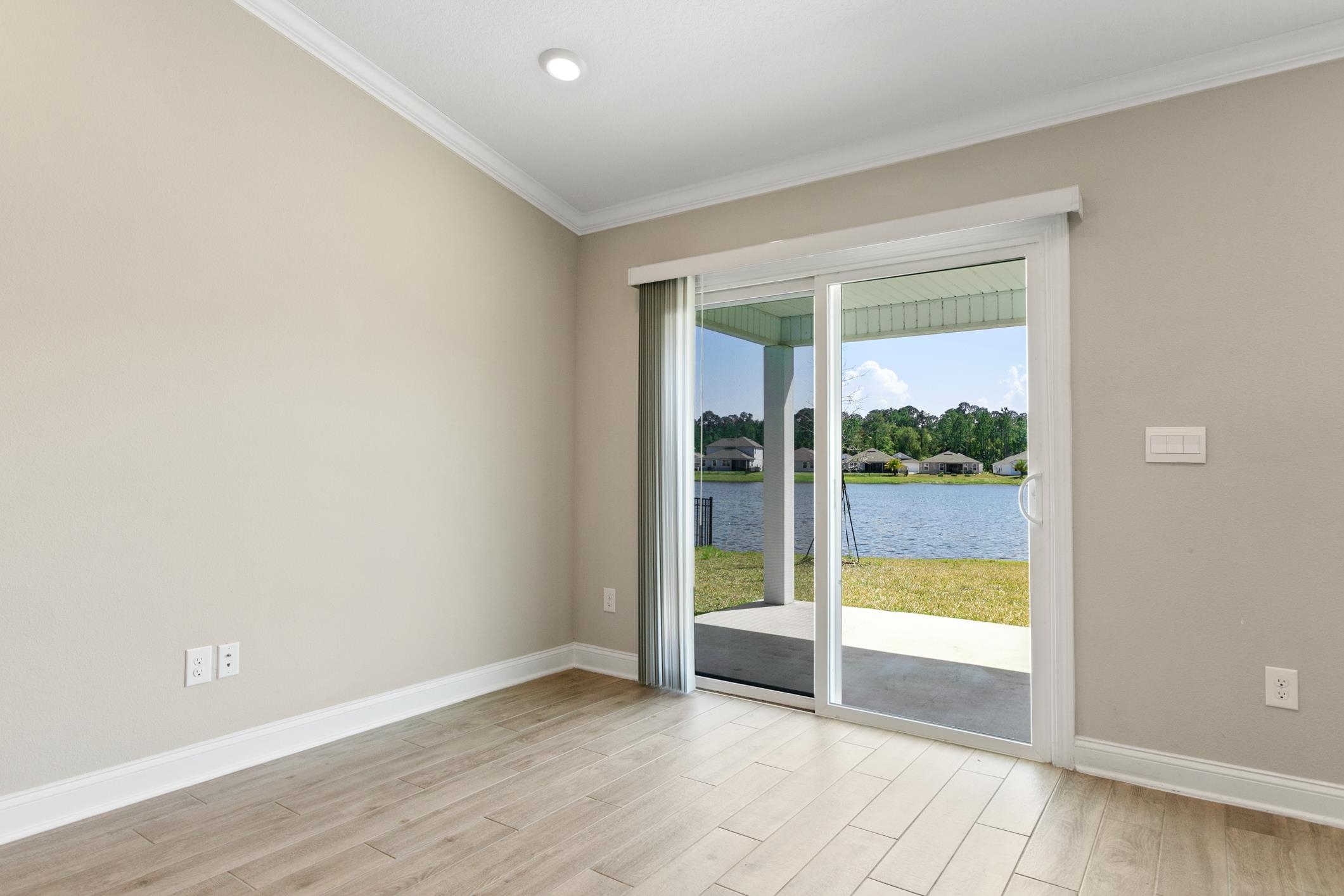 42 Huesca Court St. Augustine, FL 32084 - Photo 23 of 70 an empty room with sliding glass door and garden view