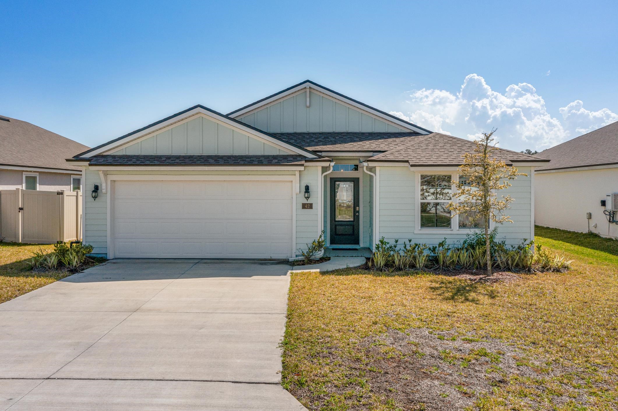 42 Huesca Court St. Augustine, FL 32084 - Photo 55 of 70 a front view of a house with a yard and garage
