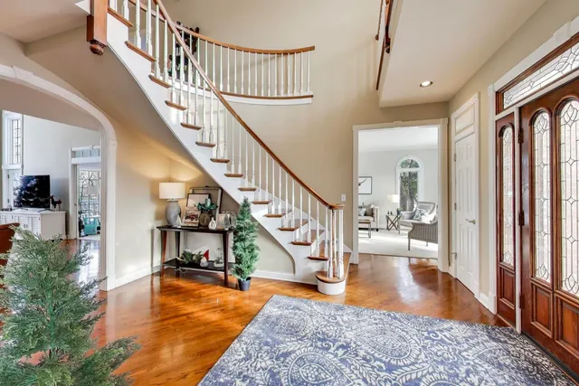 a living room with furniture a rug and a window