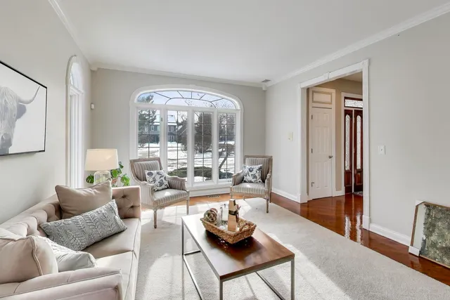 a living room with furniture a mirror and a table