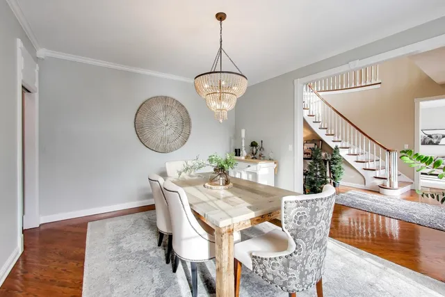 a kitchen with granite countertop wooden cabinets and chairs