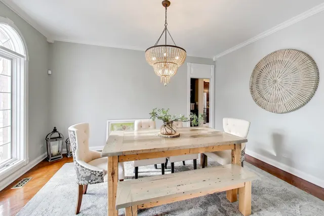 a kitchen that has a table chairs in it and wooden floors