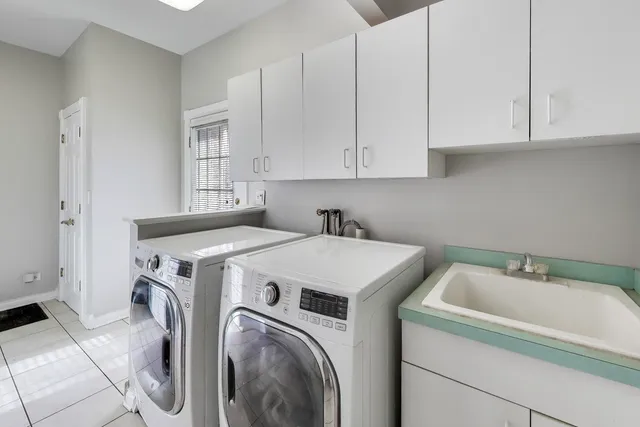 a spacious bathroom with a tub sink and mirror