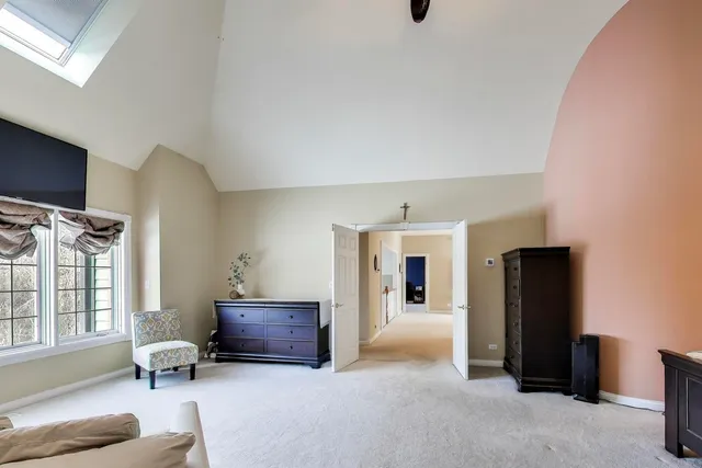 a view of an empty room with a chandelier fan and a ceiling fan