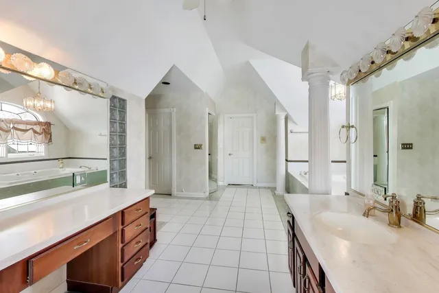 a bathroom with a sink mirror vanity and toilet