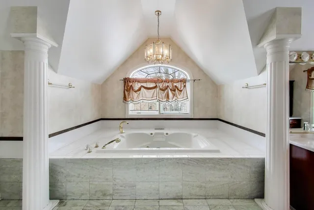 a bedroom with furniture and a window