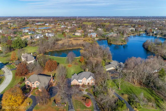 an aerial view of residential house with outdoor space and lake view