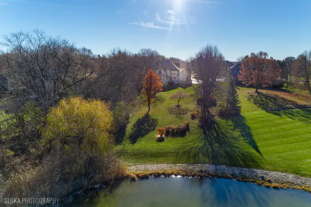 an aerial view of a house with a yard basket ball court and outdoor seating