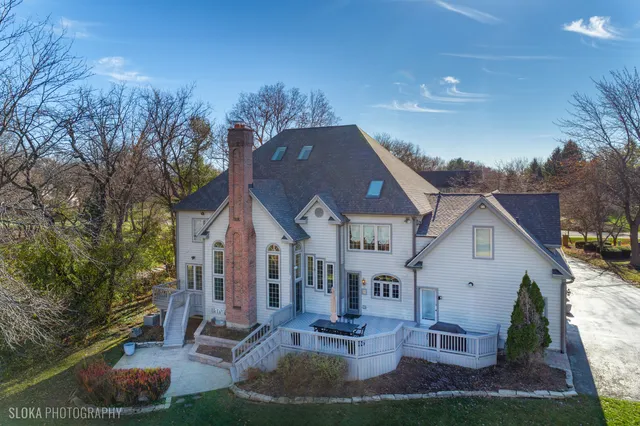 an aerial view of lake and residential houses with outdoor space