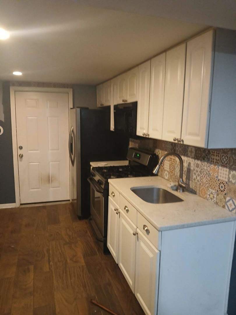 1014 West 19th Street, Unit G Chicago, IL 60608 - Photo 3 of 3 a kitchen with a sink and a refrigerator