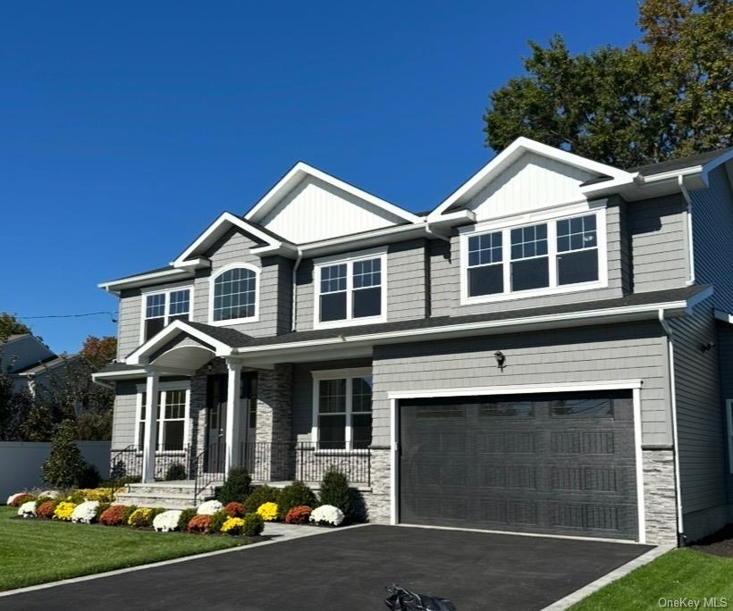 526 Park Avenue Merrick, NY 11566 - Photo 2 of 9 a front view of a house with yard and garage