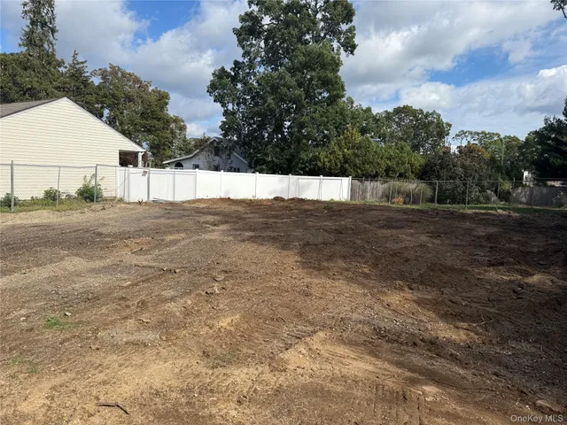 a view of yard with large trees