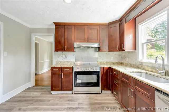 a kitchen with stainless steel appliances granite countertop a stove and a sink