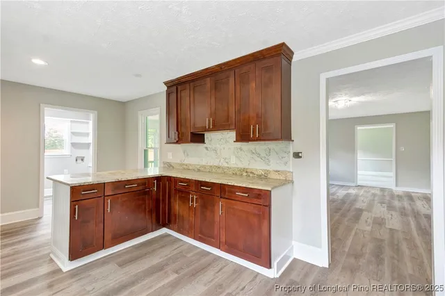 a kitchen with granite countertop wooden cabinets and white appliances