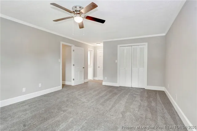 a view of an empty room with a ceiling fan