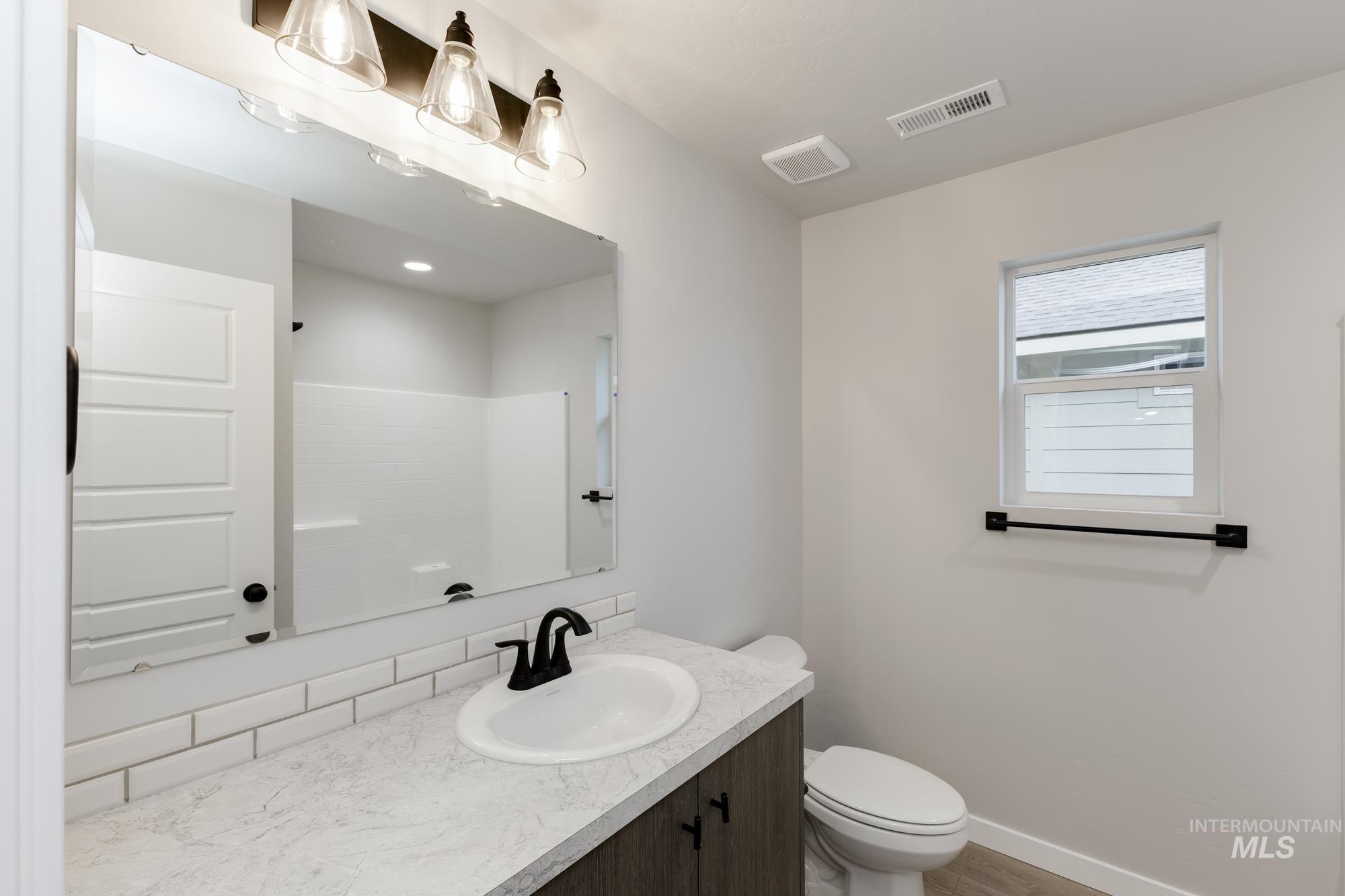 907 North Aleppo Way Meridian, ID 83642 - Photo 11 of 19 Full bath featuring vanity and a shower