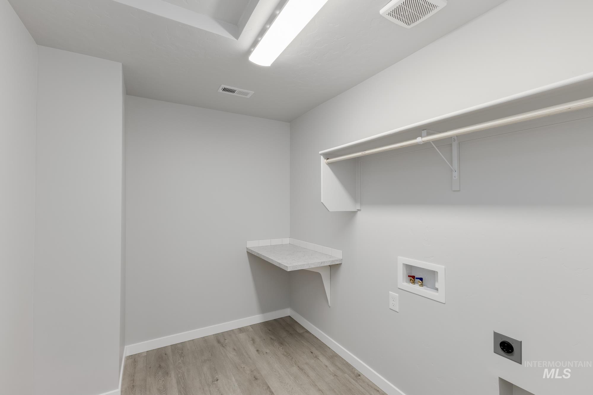 907 North Aleppo Way Meridian, ID 83642 - Photo 15 of 19 Washroom featuring light wood-style floors, electric dryer hookup, and washer hookup
