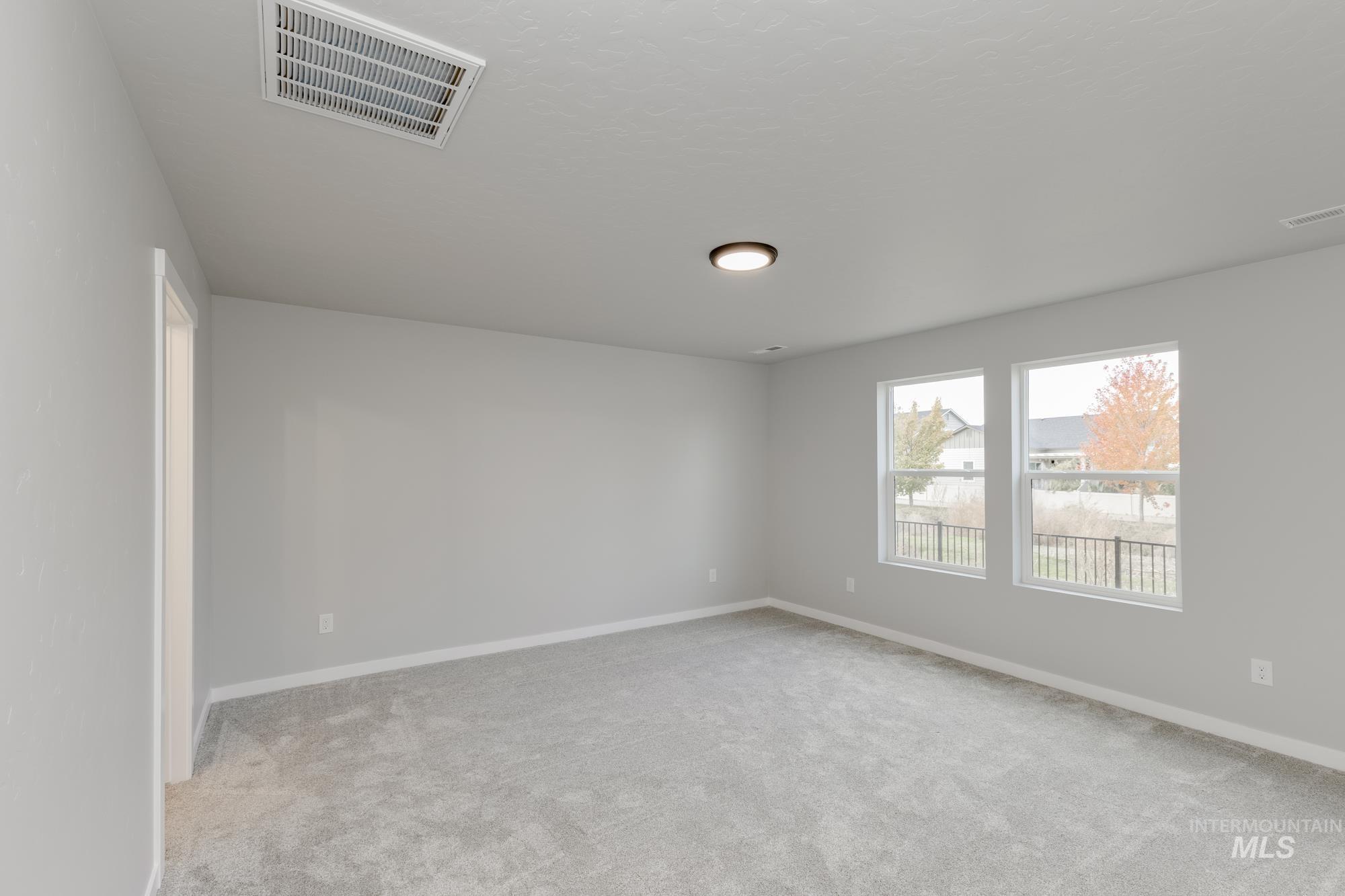 907 North Aleppo Way Meridian, ID 83642 - Photo 16 of 19 Empty room featuring light colored carpet and baseboards