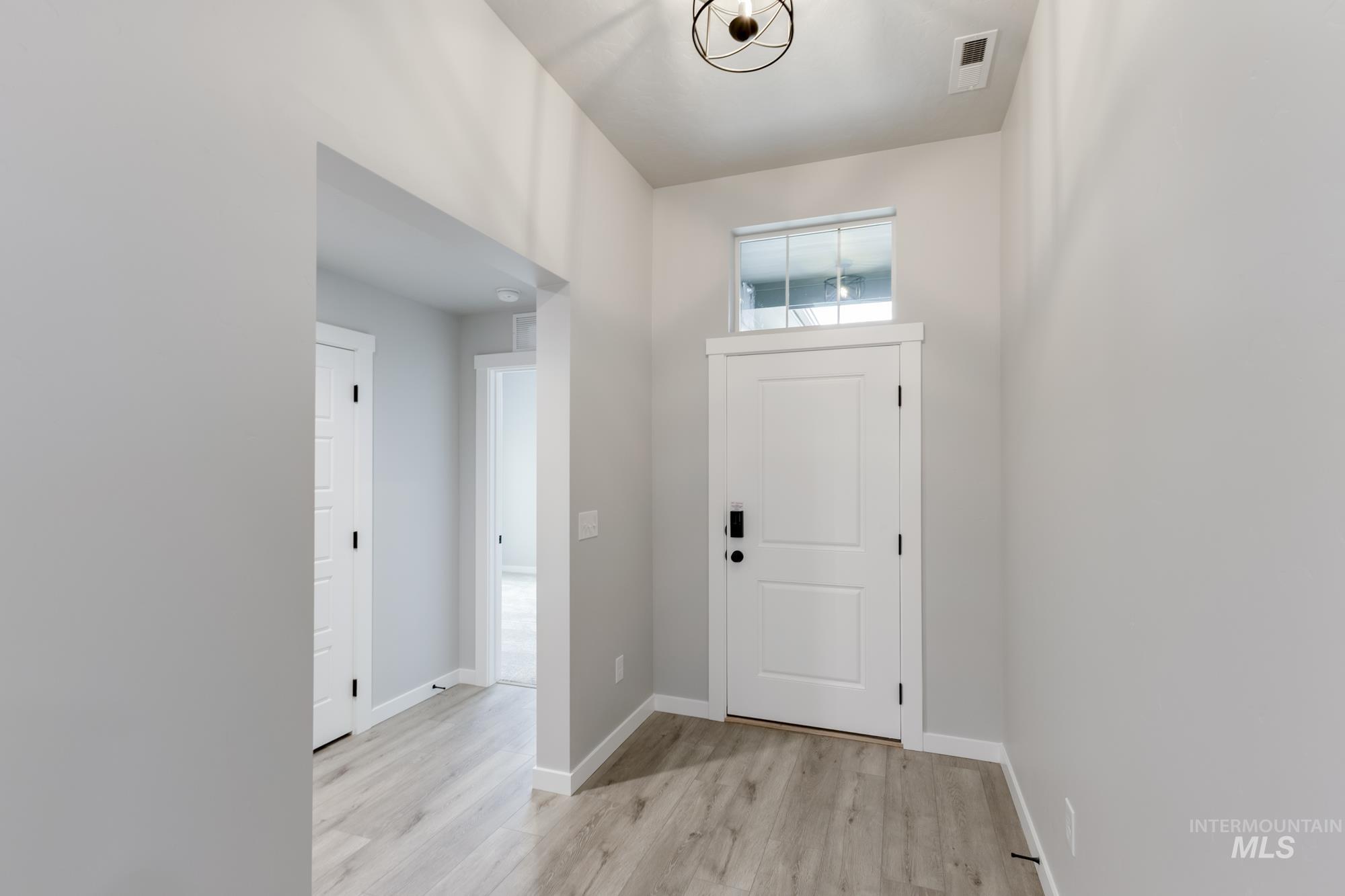 907 North Aleppo Way Meridian, ID 83642 - Photo 2 of 19 Foyer entrance with light wood-style flooring and baseboards