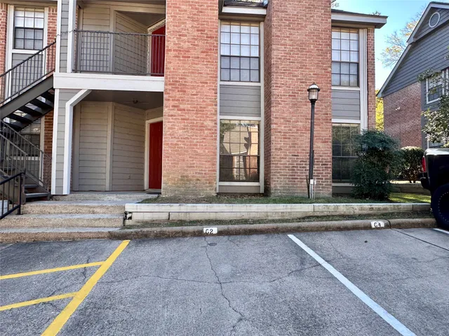 a view of a brick building next to a yard
