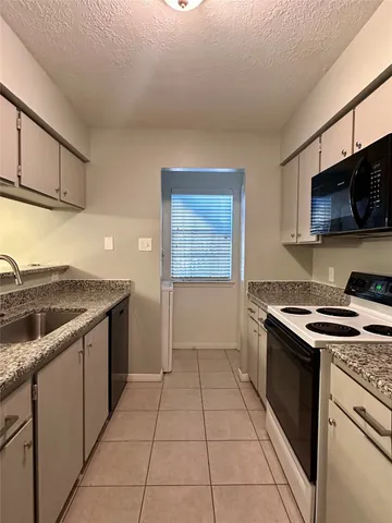 a kitchen with a stove and a sink